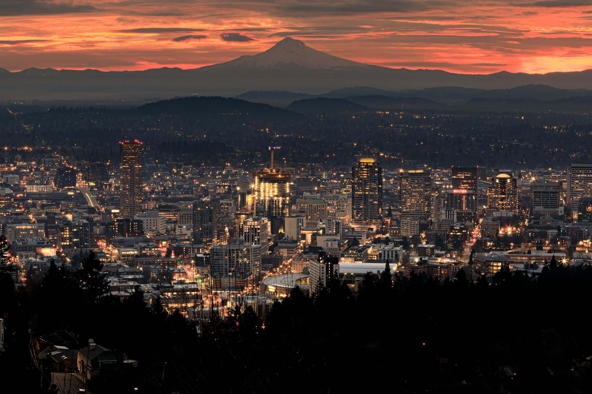 Portland's city lights at dusk, with Mount Hood behind