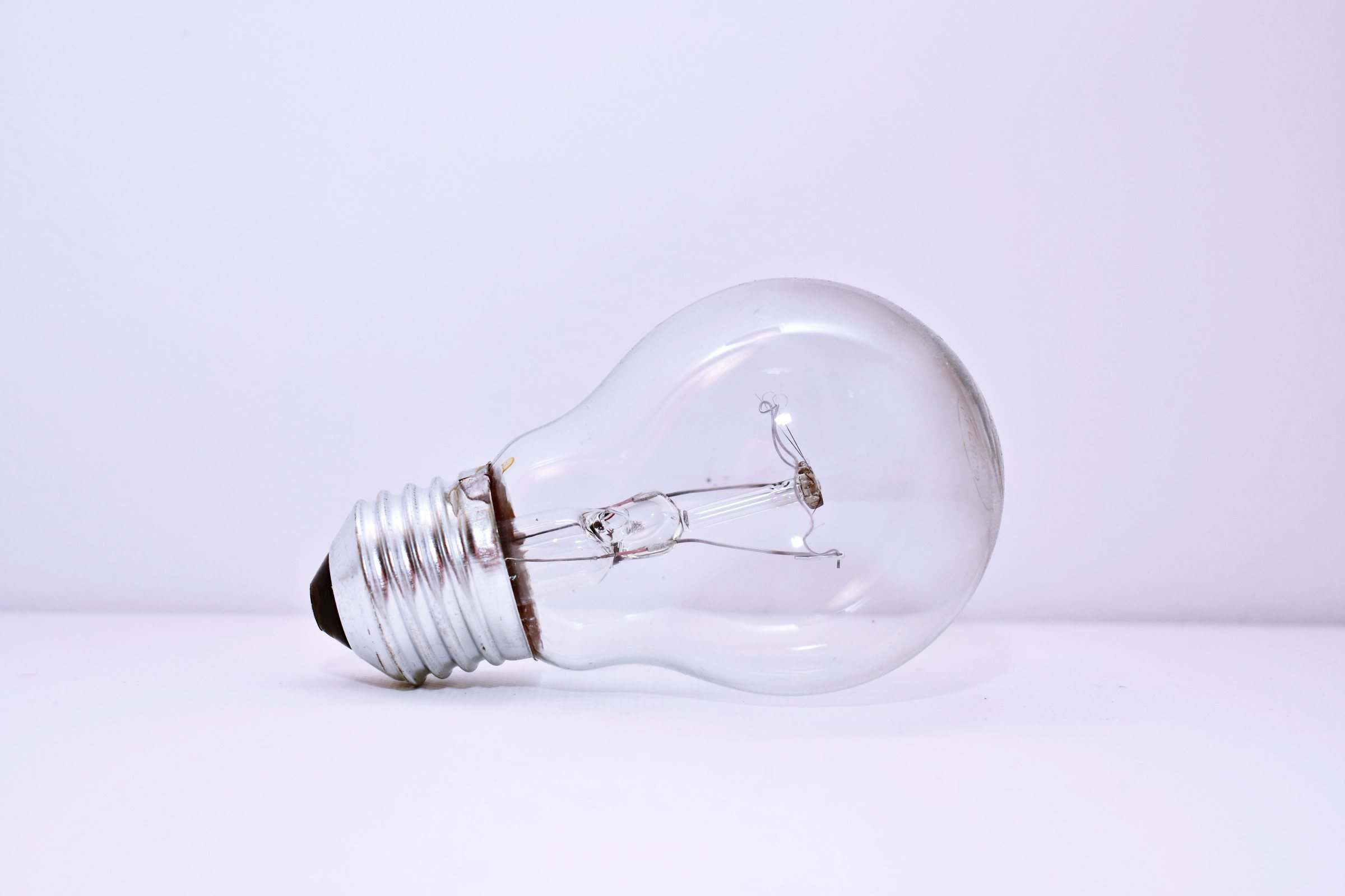 A clear incandescent light bulb on a white background